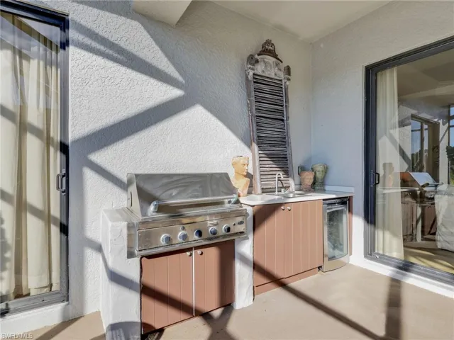 View of patio with exterior kitchen and wine cooler