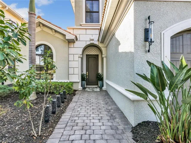 Property entrance featuring stucco siding