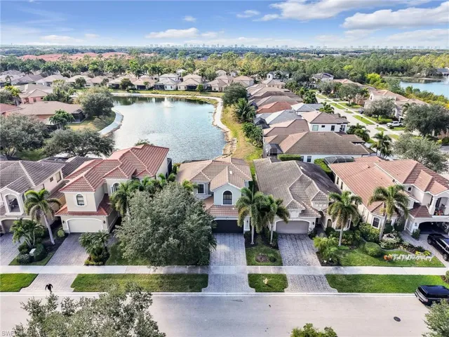 Aerial view of residential area featuring a nearby body of water