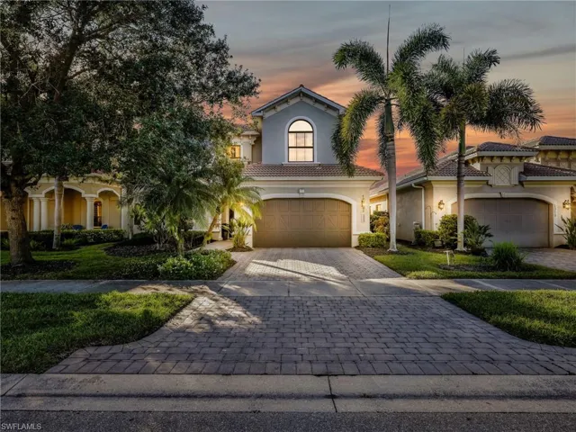 Mediterranean / spanish-style home with stucco siding, decorative driveway, an attached garage, and a tiled roof