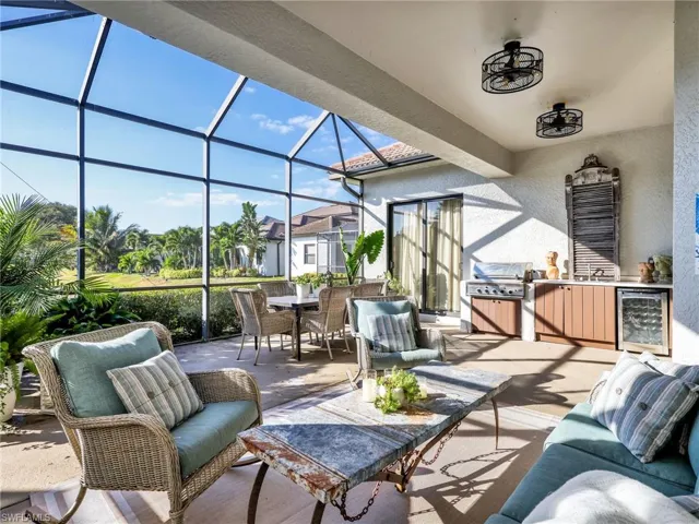 View of patio / terrace with a sunroom, a lanai, wine cooler, and an outdoor living space