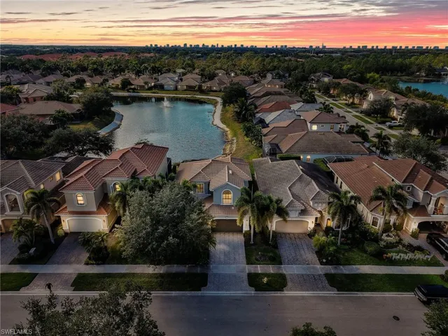 Aerial view of property's location featuring a large body of water and nearby suburban area