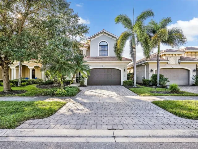 Mediterranean / spanish-style house with stucco siding, decorative driveway, an attached garage, and a tiled roof