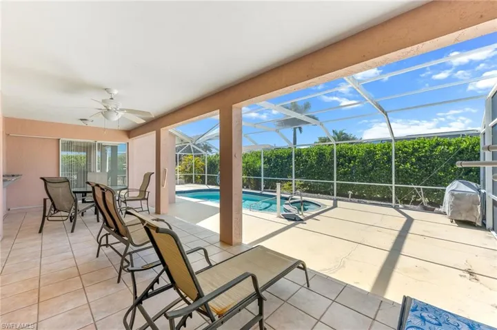 Swimming pool with a patio area, a sunroom, a lanai, and outdoor dining area