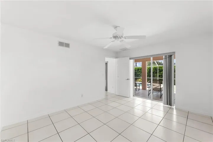 Unfurnished room featuring ceiling fan and light tile patterned floors