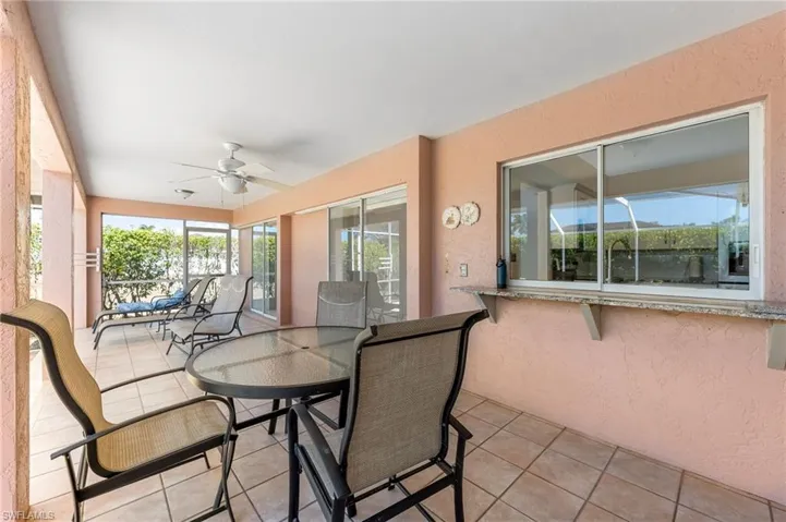 Sunroom featuring a ceiling fan and outdoor dining area