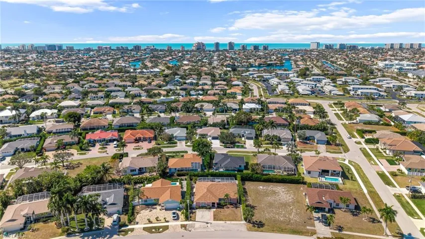 Aerial view of property's location with skyline, a nearby body of water, and nearby suburban area