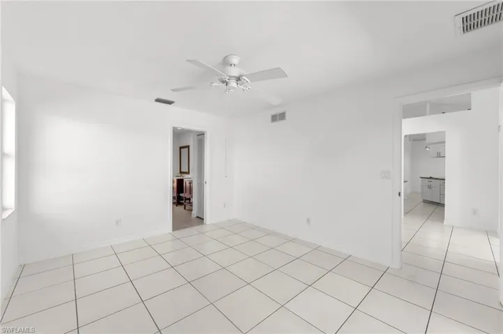 Unfurnished room featuring a ceiling fan and light tile patterned floors