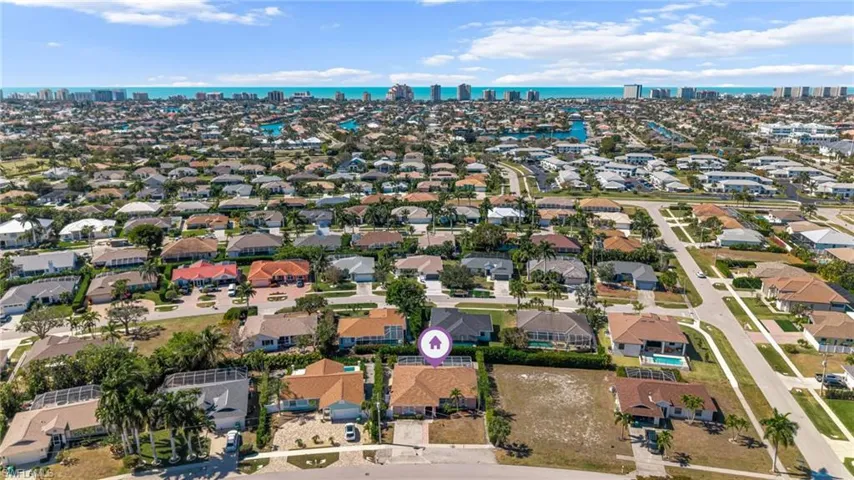 Aerial view of property and surrounding area with nearby suburban area