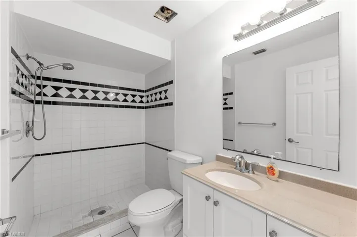 Full bathroom featuring a shower stall and vanity