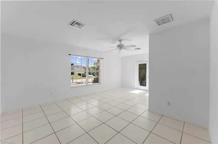 Unfurnished room featuring ceiling fan and light tile patterned floors