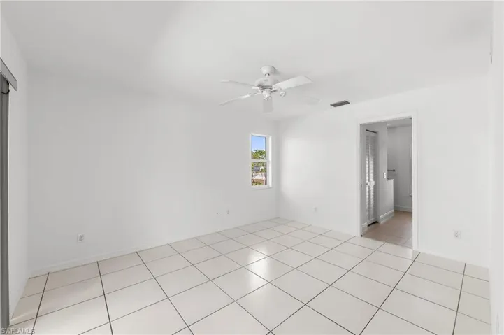 Unfurnished room featuring a ceiling fan and light tile patterned floors