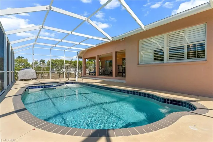 Integrated pool / spa with a patio, a sunroom, and a lanai