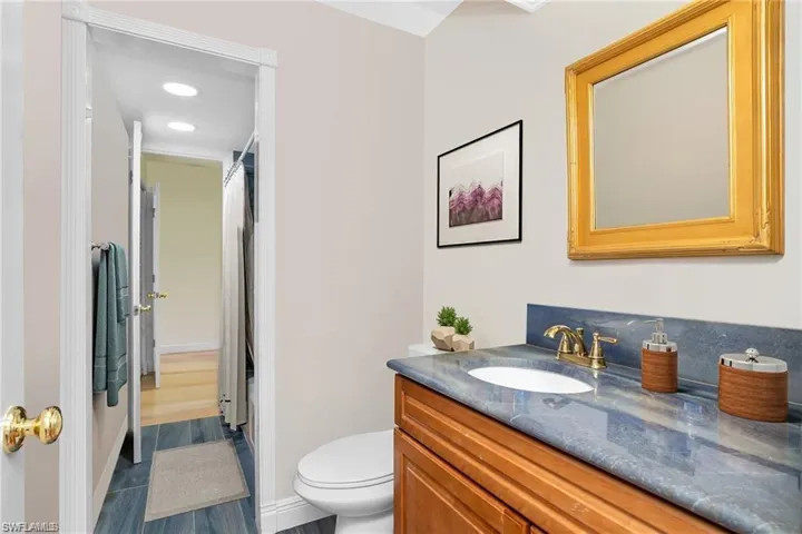 Bathroom with a shower with shower curtain, vanity, recessed lighting, and dark wood-style flooring