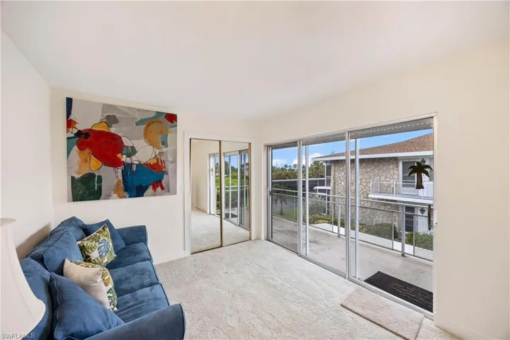Living room with carpet and a water view