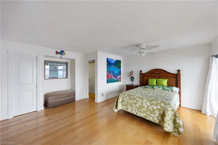 Bedroom with light wood-style floors and ceiling fan