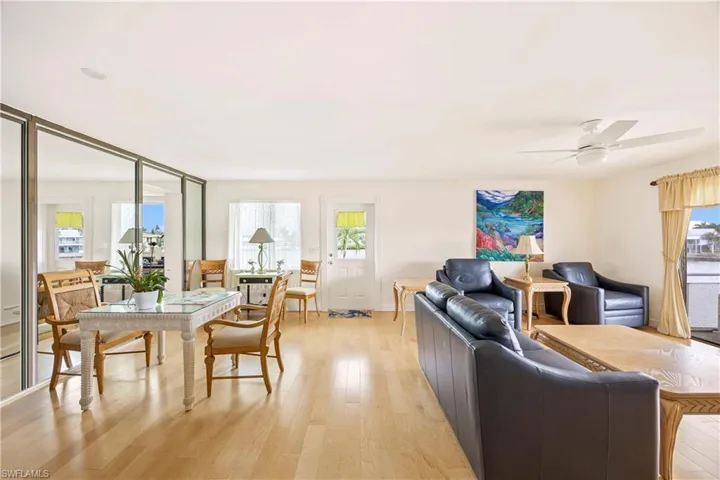 Living area with light wood-style floors and ceiling fan