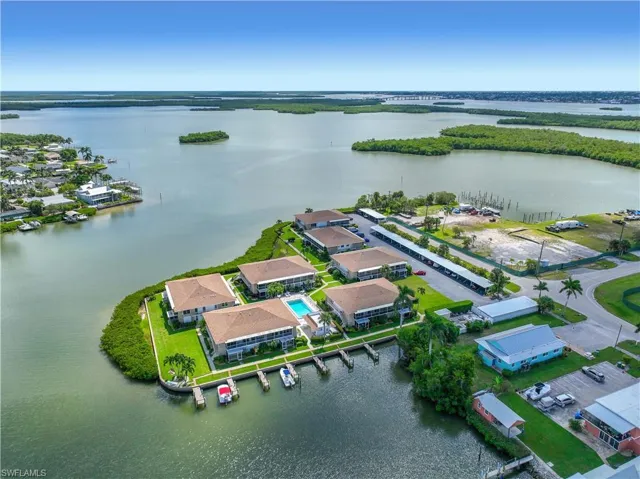 Aerial perspective of suburban area featuring a nearby body of water