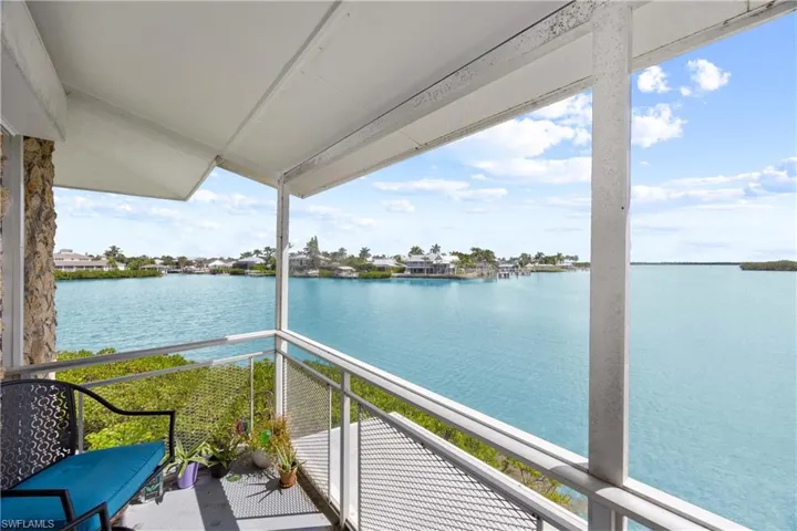Balcony with a water view and a sunroom