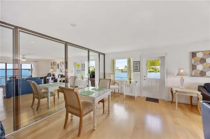 Dining space with plenty of natural light, light wood-style flooring, and a water view