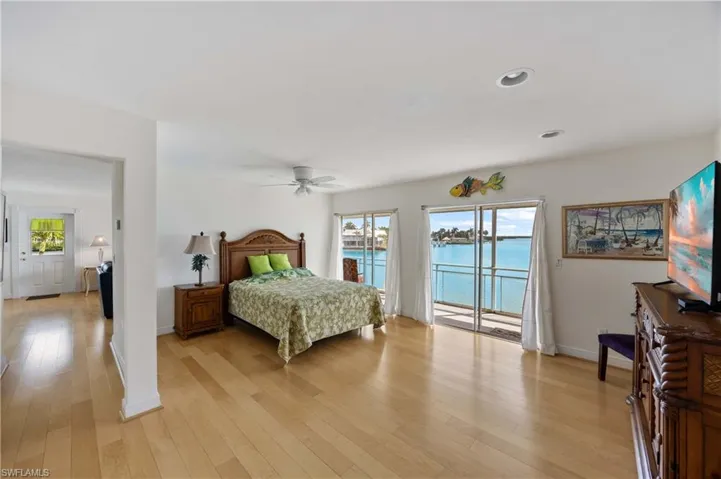 Bedroom with light wood-style floors, access to exterior, ceiling fan, and recessed lighting