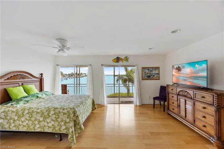 Bedroom featuring light wood finished floors, access to outside, a ceiling fan, and recessed lighting