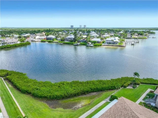 Aerial view of residential area featuring a large body of water