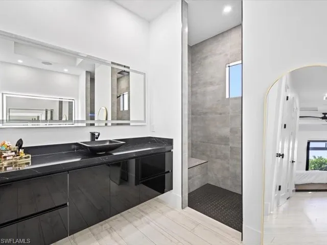 Ensuite bathroom with vanity, walk in shower, and recessed lighting