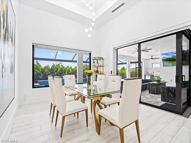 Dining space featuring light wood-type flooring, a high ceiling, and ceiling fan
