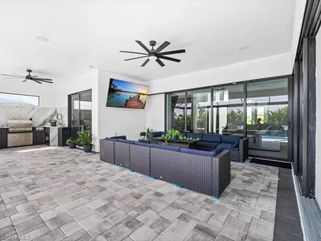 Living area featuring a ceiling fan and plenty of natural light