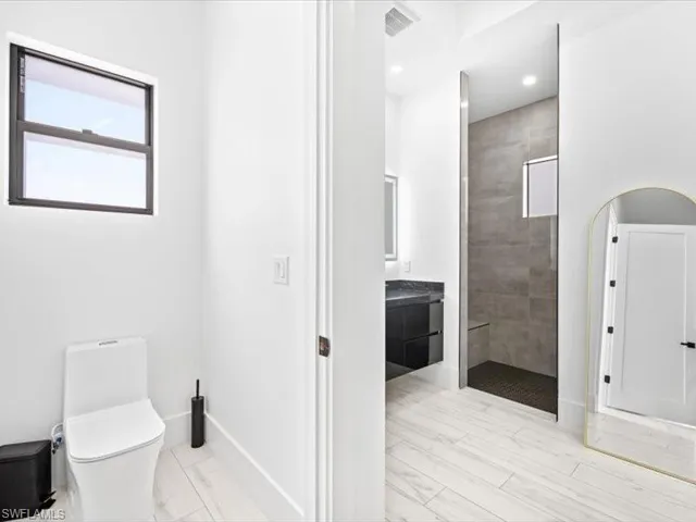 Full bath with a walk in shower, vanity, and recessed lighting