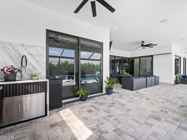 View of patio / terrace with outdoor seating, a ceiling fan, and an outdoor pool