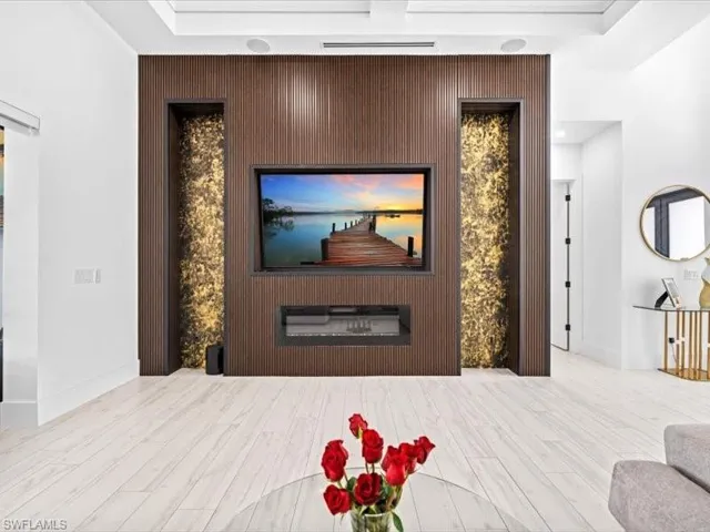 Living room featuring an accent wall and light wood finished floors