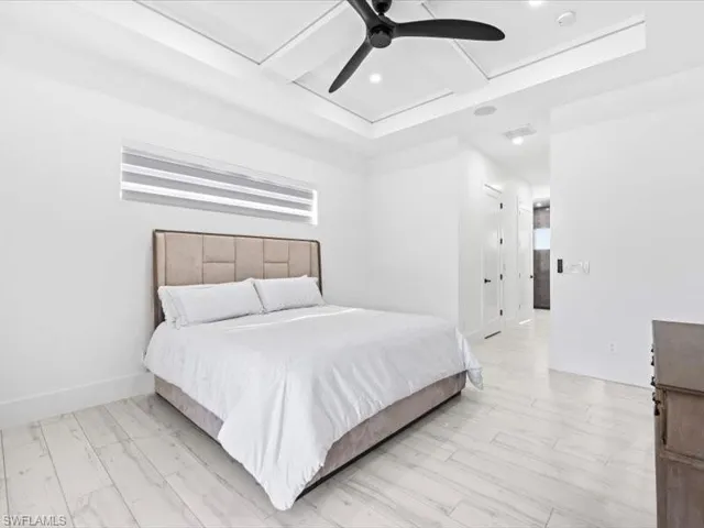 Bedroom featuring coffered ceiling, a ceiling fan, a closet, and recessed lighting