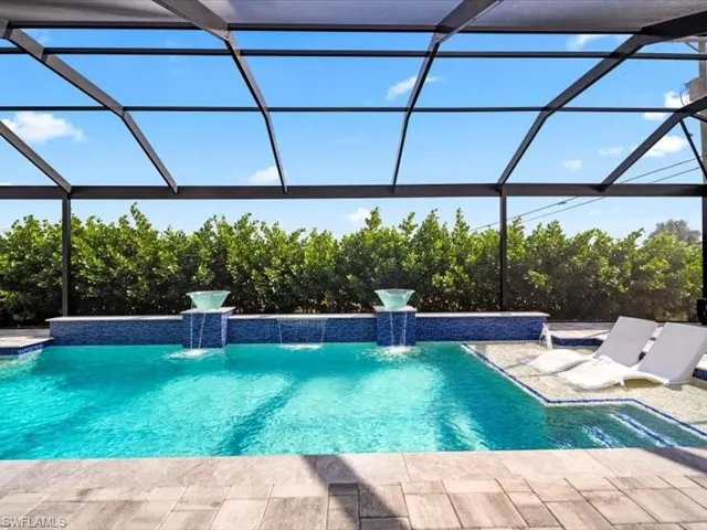 Outdoor pool with glass enclosure, a sunroom, and a patio area pool size 13 x 33