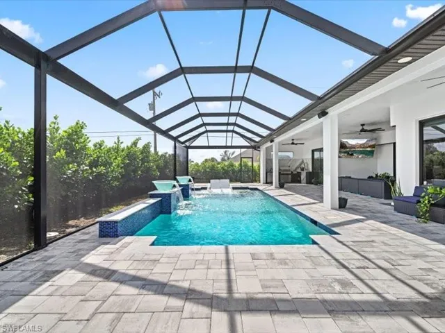 Swimming pool featuring a sunroom, a patio, and a lanai