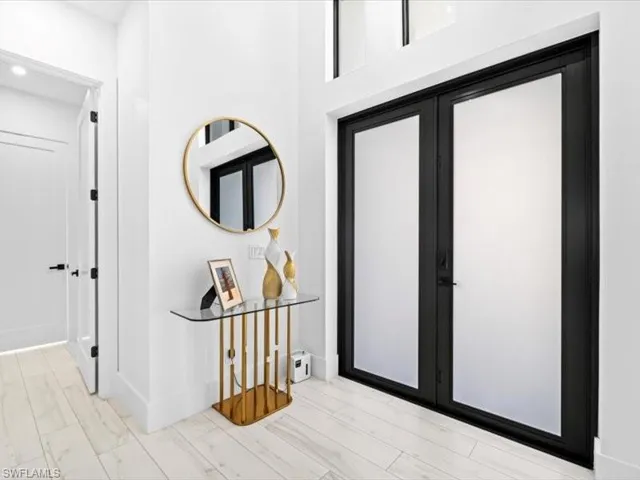Foyer entrance featuring french doors and baseboards