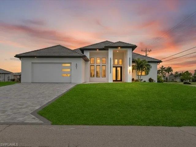View of front facade featuring a yard, decorative driveway, stucco siding, a garage, and a tile roof