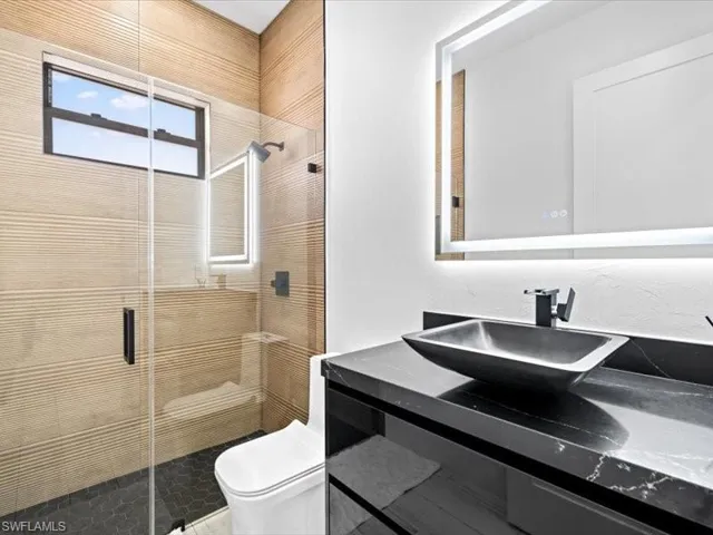Full bathroom featuring vanity and a shower stall