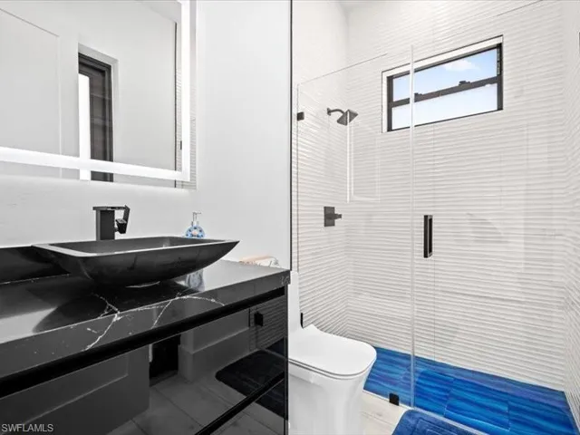 Full bath with vanity and a shower stall