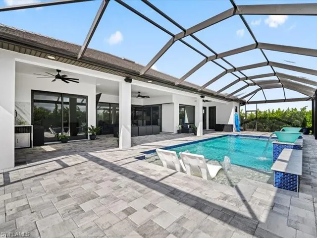 Outdoor pool featuring a sunroom, a lanai, and a patio area
