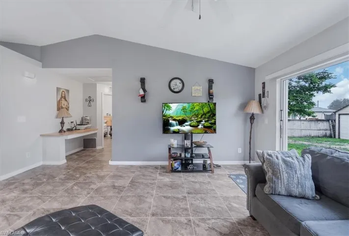 Living area featuring lofted ceiling and ceiling fan