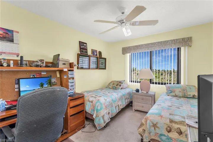 Bedroom featuring ceiling fan and carpet flooring