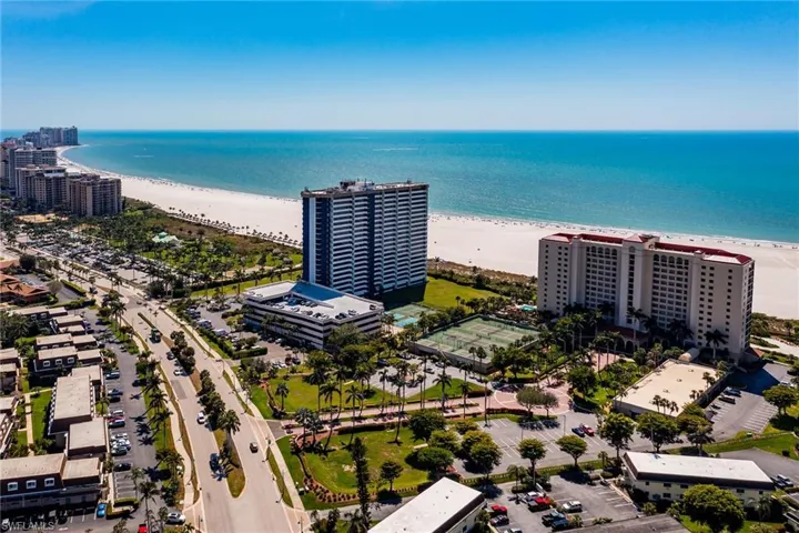 Drone / aerial view featuring a city view, a water view, and a beach view