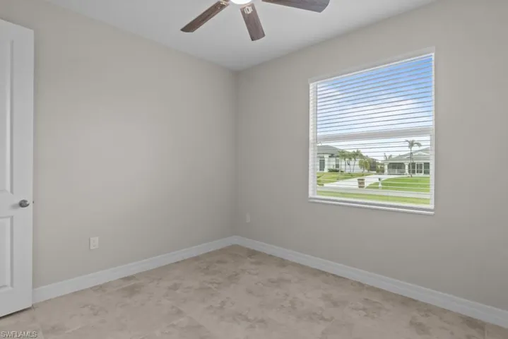 Spare room featuring baseboards and ceiling fan