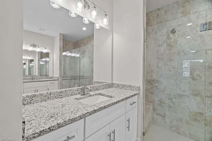 Bathroom with a stall shower and vanity