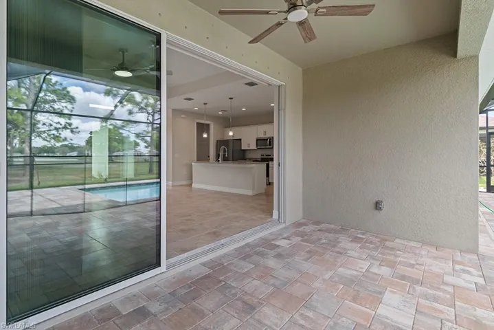View of patio / terrace with ceiling fan, a lanai, and an outdoor pool