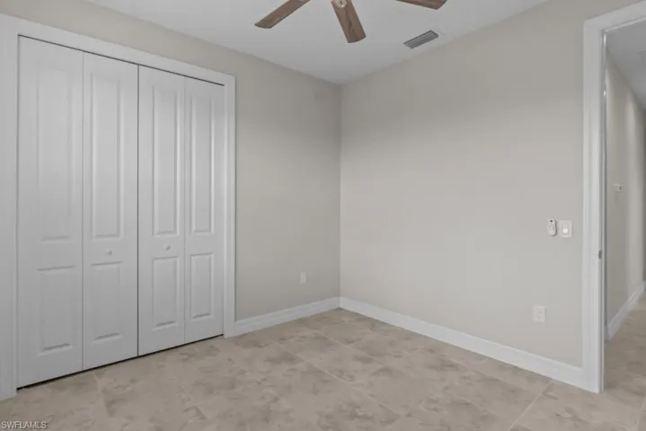 Unfurnished bedroom with a closet and ceiling fan