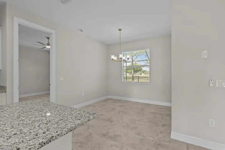 Unfurnished dining area featuring hanging lights and ceiling fan