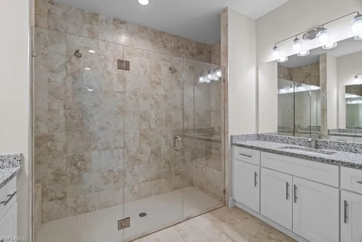 Bathroom featuring vanity and a stall shower